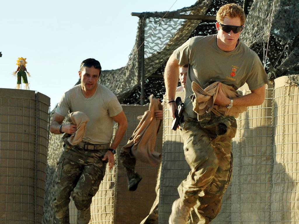 Prince Harry, far right, served two tours of Afghanistan while serving in the British army. Picture: AFP