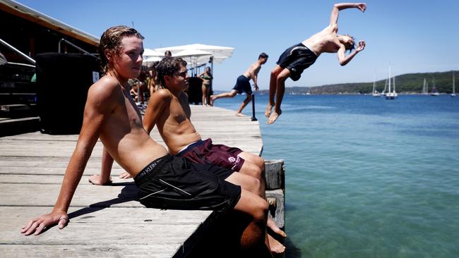 Schoolmates Josh Bowles, Lachlan Taylor, Tom Procter and Baxter Stuart, all 15, enjoy the warm weather at Manly wharf in Sydney on Sunday. Picture: Nikki Short