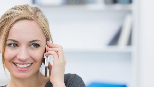 Close-up of business woman using mobile phone in office