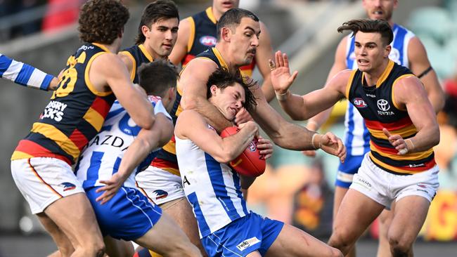 Taylor Walker takes Kayne Turner a little high in a tackle. Picture: Steve Bell/Getty Images