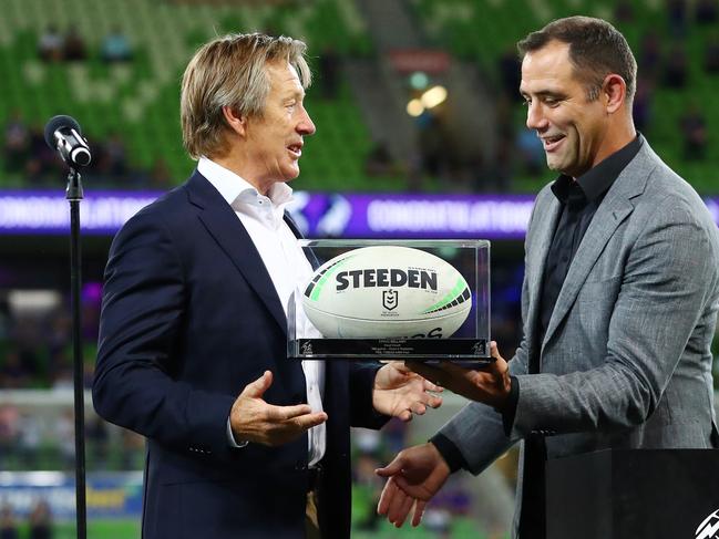 Craig Bellamy receives the game ball from Cameron Smith after coaching his 500th game for the club. Picture: Kelly Defina/Getty Images