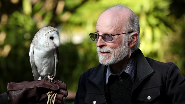 Graham Medlin from the South Australian Museum, who leads a project sifting through barn owl droppings to find clues to what small animals are in a region. Graham at the Adelaide Zoo with Cooper the barn owl. Picture: Calum Robertson