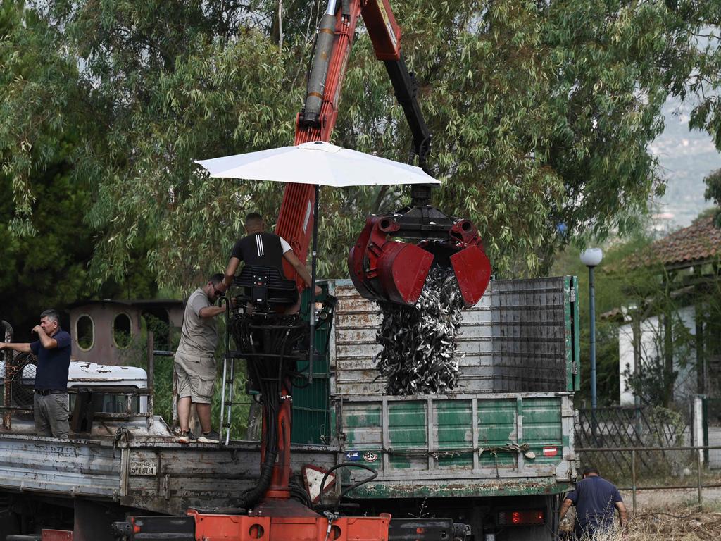 Workers operate a mobile crane to remove dead fish floating from the Xiria River near Volos, central Greece, on August 28. Picture: Sakis Mitrolidis/AFP