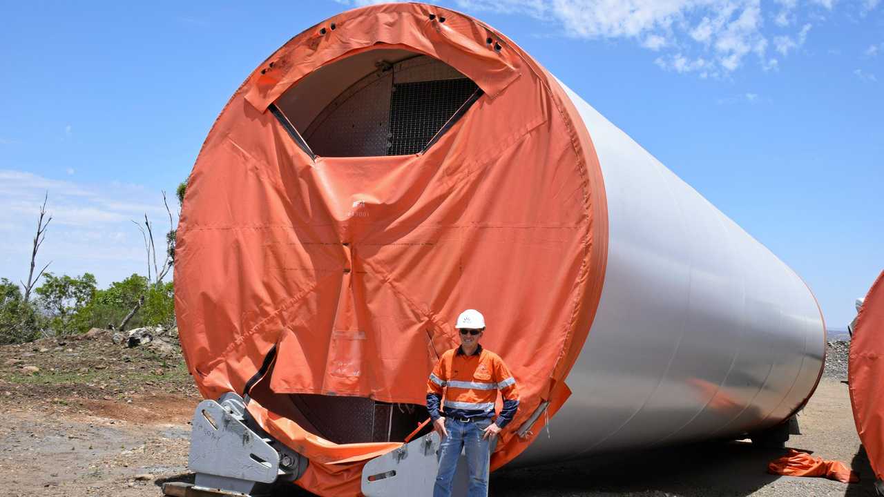 AGL's Michael Yeo next to one of the 30 metre tower sections of one of the wind turbines. Picture: Matt Collins