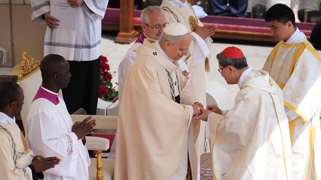 Cardinal Luis Antonio Tagle places the Ring of the Fisherman on the finger of Pope Leo XIV as the pontiff celebrates a Mass for the formal inauguration of his pontificate. Picture: Getty