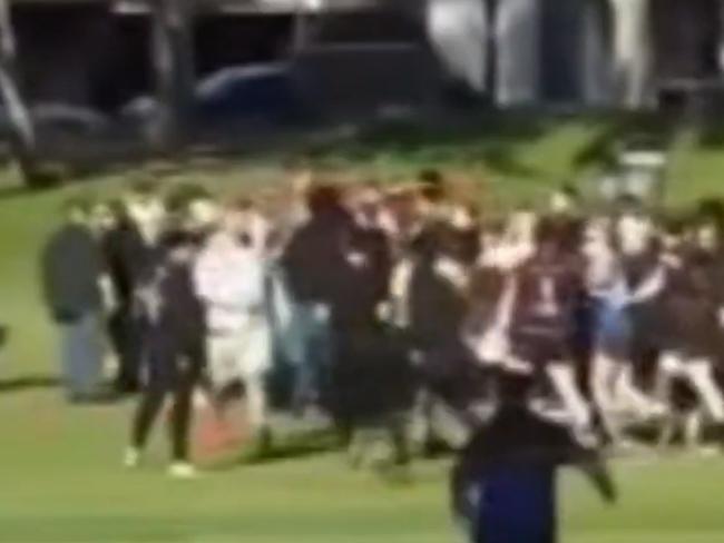Video has emerged of a brawl between spectators and players breaking out at the end of the South Australian Rugby League grandfinal at Mitchell Park on Sunday afternoon