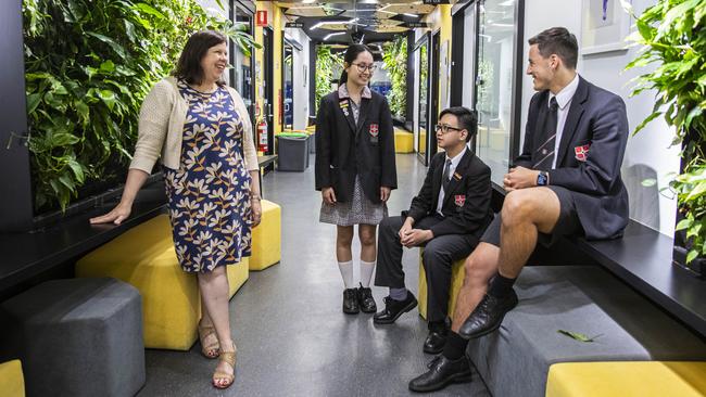 Caroline Chisholm Catholic College deputy principal Stephanie Banks with Nhi Nguyen, Christian Nguyen and Lachlan Meilak at the Braybrook campus. Picture: Aaron Francis