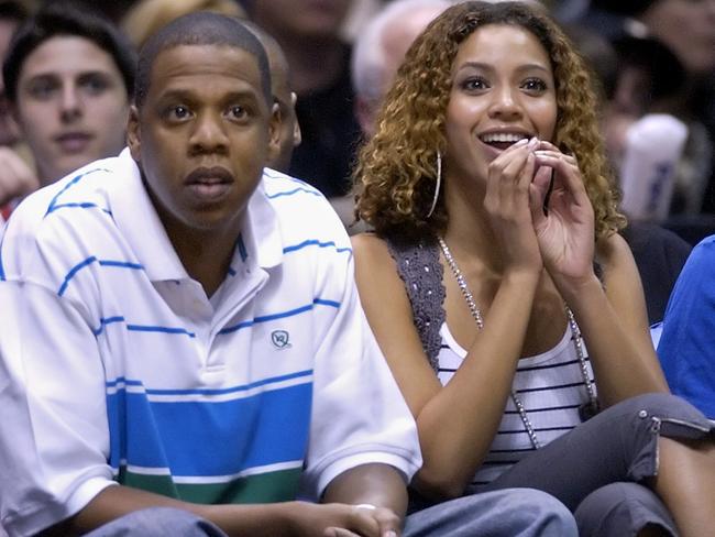 Recording artists Jay-Z, left, and Beyonce watch the New Jersey Nets beat the Indiana Pacer, 92-86, during first round NBA playoffs basketball Tuesday night, May 2, 2006 in East Rutherford, N.J. (AP Photo/Bill Kostroun)