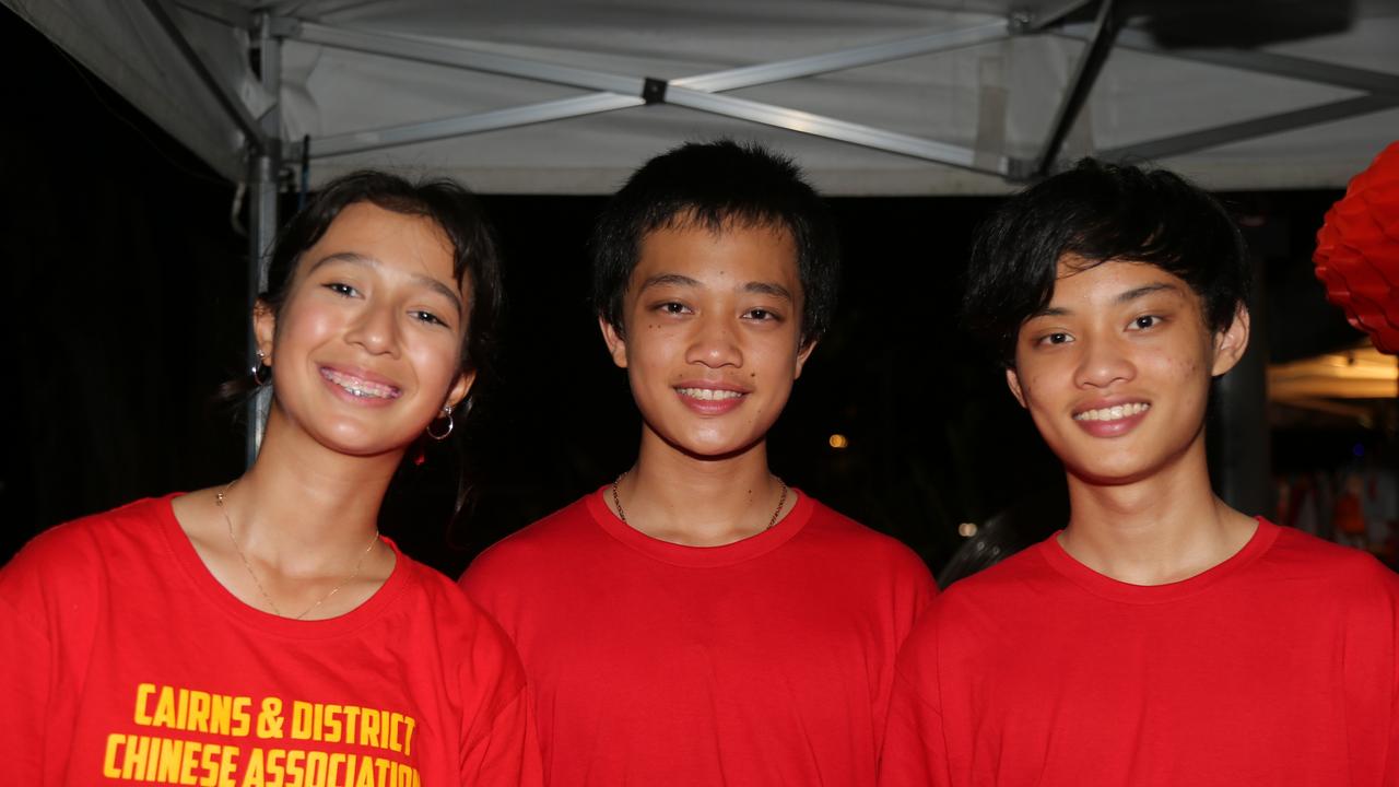 CADCAI volunteers Kassia (12), Ethan (14), and Adrian (16) celebrate the last night of Chinese New Year festivities in Cairns. Picture: Kate Stephenson