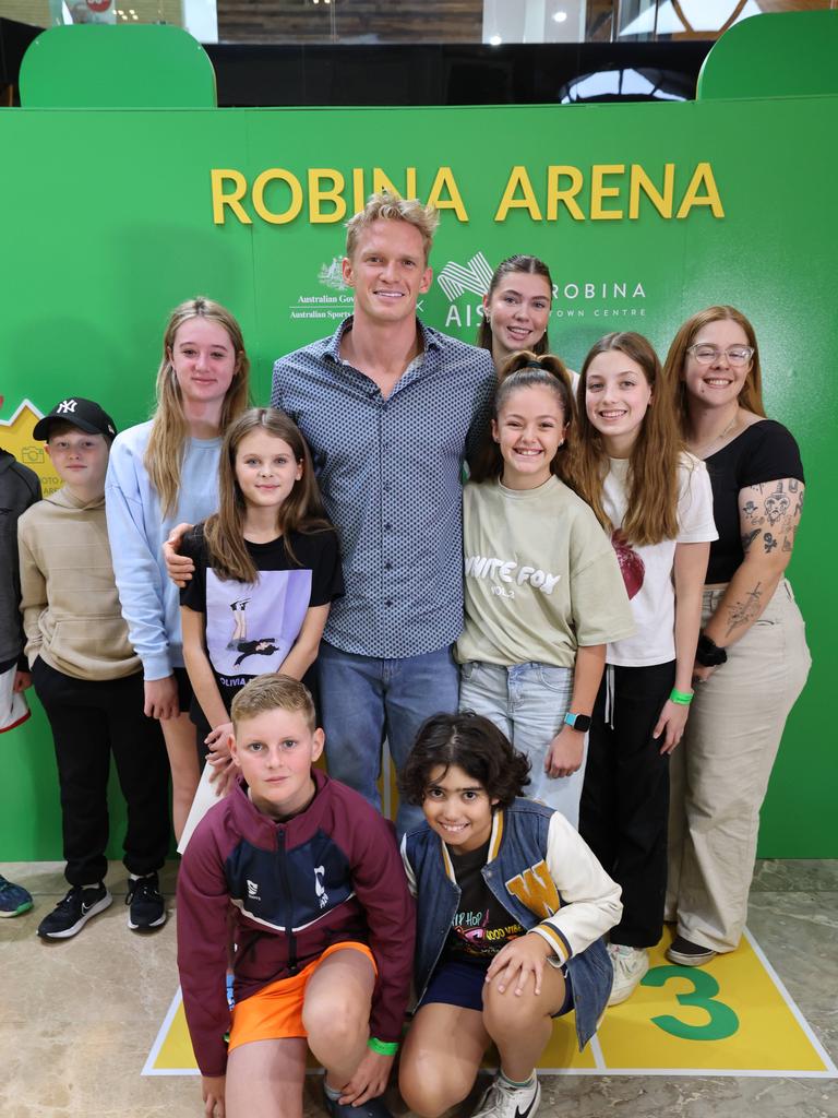 Fans pose for a photo with Cody Simpson at a meet-and-greet at Robina Town Centre outside Myer . Picture Glenn Hampson