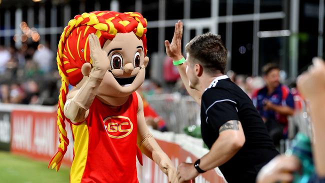 A fan high fives the Gold Coast Suns AFLW mascot at the Gold Coast Suns AFLW and Geelong Cats at Harrup Park. Picture: Tony Martin