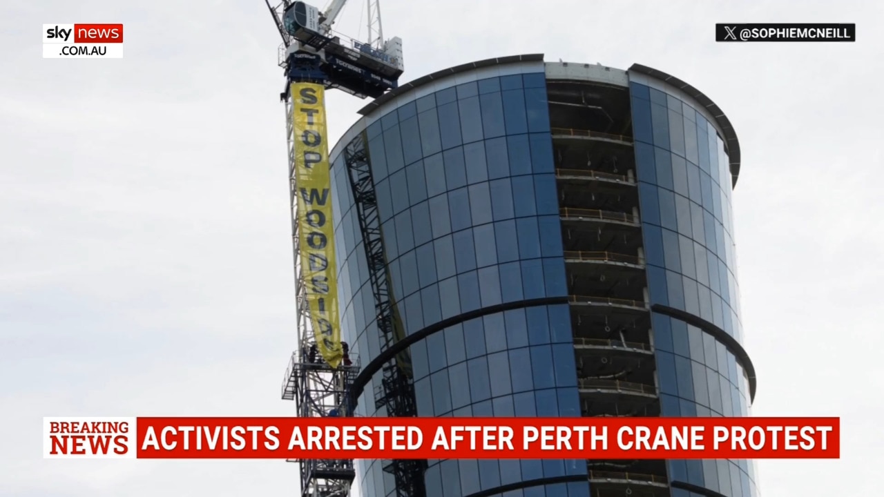 Four climate activists arrested after scaling crane outside Woodside’s Perth headquarters