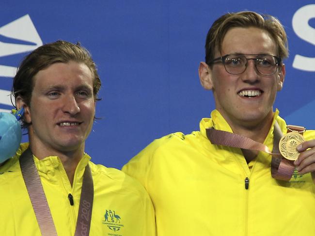 Men's 400m freestyle gold medalist Australia's Mack Horton, right, stands with silver medalist and compatriot Jack McLoughlin on the podium at the Aquatic Centre during the 2018 Commonwealth Games on the Gold Coast, Australia, Thursday, April 5, 2018. (AP Photo/Rick Rycroft)