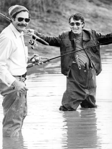 North Melbourne coach Ron Barassi and jockey Roy Higgins fishing for trout at Carbine Lodge, Narre Warren, in 1975.