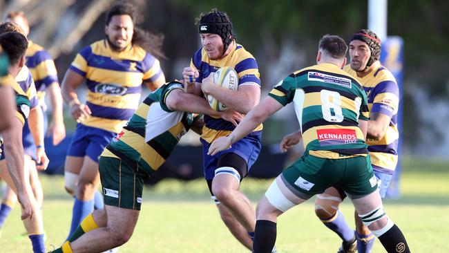 Gold Coast District Rugby Union match between Gold Coast Eagles and Surfers Paradise at James Overell Park. Photo of Eagles lock Angus Blake is tackled by Surfers No.8 Jono Makris. Picture: Richard Gosling