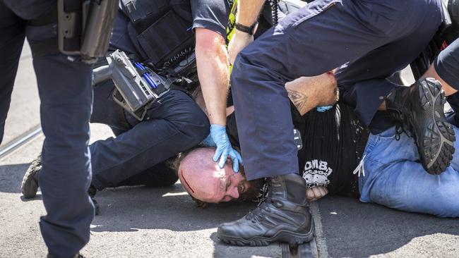 Police forcibly arrest protesters. Picture: Jake Nowakowski