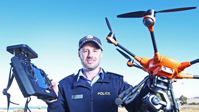 Tasmanian police officer Senior Sergeant and chief pilot Mark Forteath shows off a new drone that is being used throughout the state. Picture: ZAK SIMMONDS