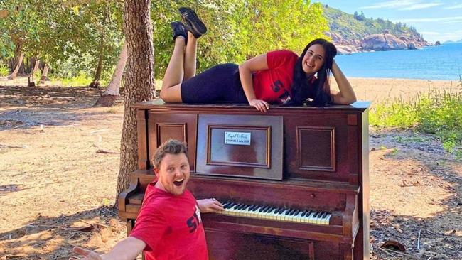 Star 106.3's Brady Ellis and Crystal Vas with the piano they delivered to Radical Bay, Magnetic Island in July. It has since been destroyed.