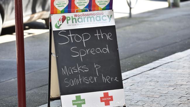 A sign advertising masks and hand sanitiser is seen outside a pharmacy on in Woolloomooloo in Sydney. Picture: Peter Parks/AFP