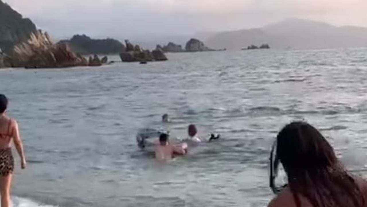 Another swimmer tried to help the man with a paddleboard