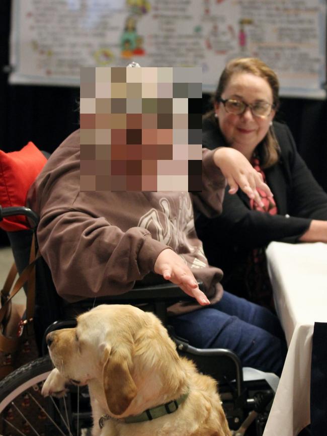 Witness Chloe (pseudonym) beside Senior Counsel Assisting Kate Eastman AM SC and Guide Dogs Tasmania facility dog Ziggy at the Royal Commission into Violence, Abuse, Neglect and Exploitation of People with Disability in Hobart on Monday. Picture: Provided by the Royal Commission.