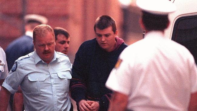 Paul Denyer being escorted by police.