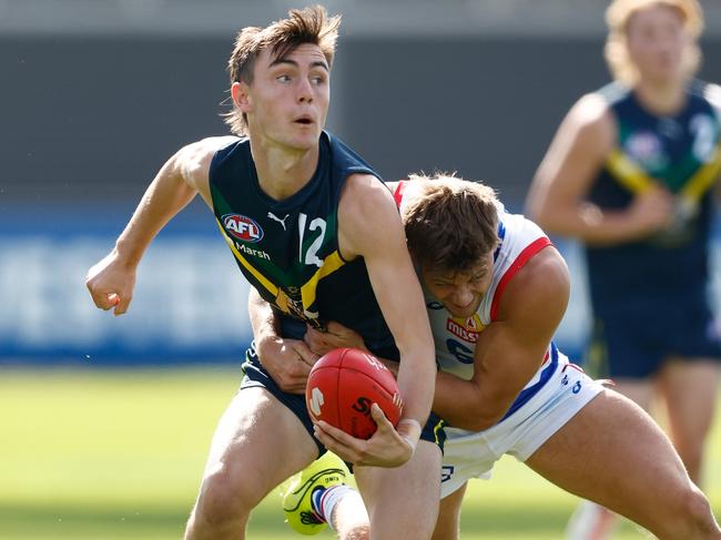 MELBOURNE, AUSTRALIA - APRIL 27: Jagga Smith of the AFL Academy is tackled during the 2024 AFL Academy match between the Marsh AFL National Academy Boys and Footscray Bulldogs at Whitten Oval on April 27, 2024 in Melbourne, Australia. (Photo by Michael Willson/AFL Photos via Getty Images)