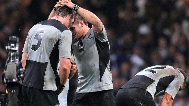 All Blacks players Ali Williams, captain Richie McCaw and Luke McAlister look dejected after France defeated New Zealand in their 2007 World Cup quarter-final in Cardiff.