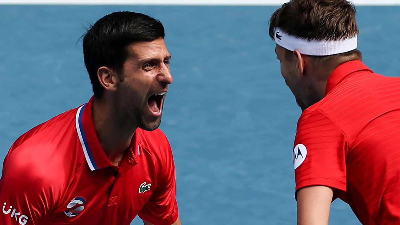 Serbia's Novak Djokovic celebrates with teammate Filip Krajinovic after winning against Canada's Milos Raonic and Denis Shapovalov during their group A men's doubles match. Picture: David Gray/AFP