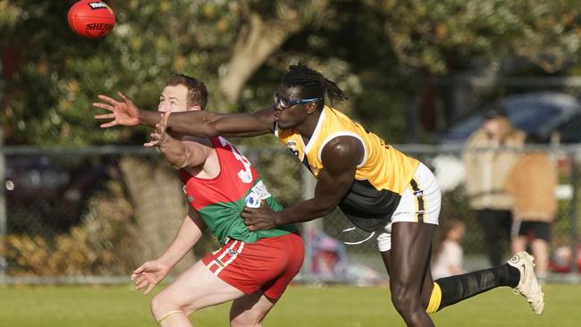 YCW’s Bassirou Faye battles it out with Pines’ Beau Hendry. Picture: Valeriu Campan