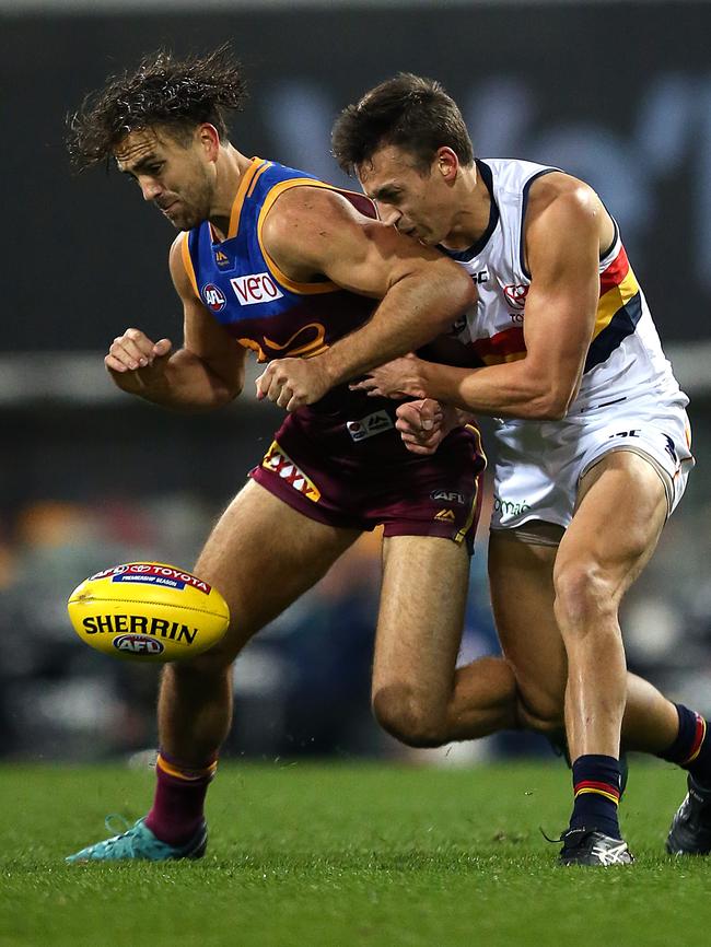 Rhys Mathieson of the Lions collides with Tom Doedee of the Crows at the Gabba on Saturday. Picture: AAP Image/Jono Searle