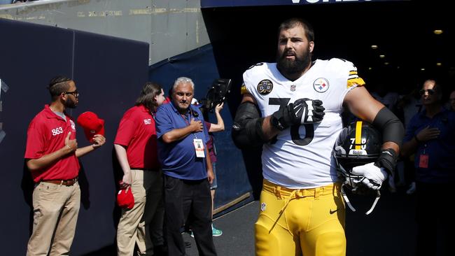 Pittsburgh Steelers player and former soldier Alejandro Villanueva stands by himself in the tunnel for the national anthem at the weekend. Picture: AP