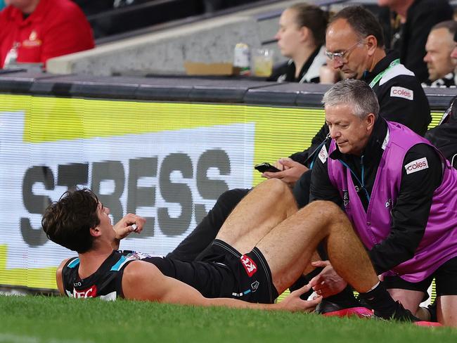 Connor Rozee has his hamstring assessed. Picture: Sarah Reed/AFL Photos via Getty Images