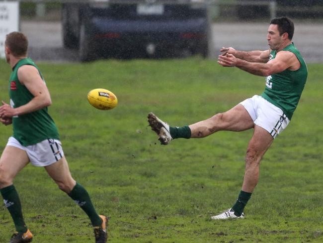 Michael Firrito takes a kick for Gembrooke Cockatoo. Picture: Stuart Milligan