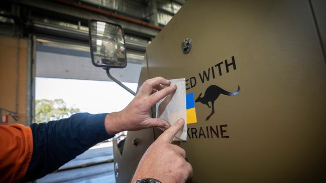 The ‘United with Ukraine’ decal is applied onto the first of fourteen M113AS4 Armoured Personnel Carriers bound for Ukraine.