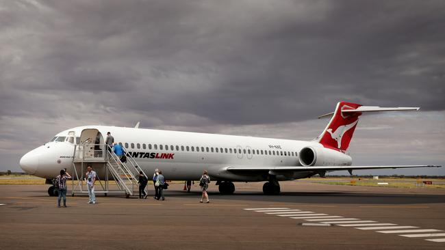 Passengers board a Qantas Link 717 at Alice Springs airport.  Flight services  between Alice and Darwin are being upgraded from a B717 to a B737 aircraft. Picture: Stuart McEvoy