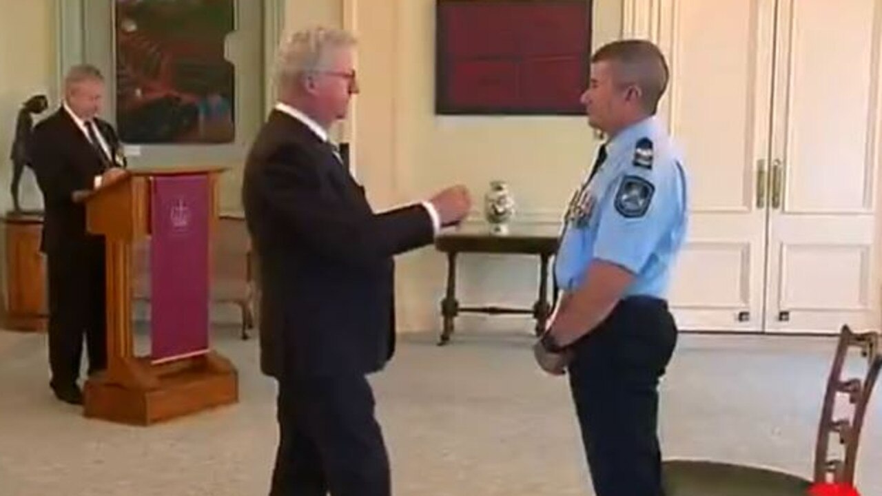 Senior Sergeant Bradyn Murphy is honoured with a Bravery Medal by then Governor-General, His Excellency David Hurley, at a ceremony in Canberra in March 2020. The Bravery Medal and a Group Bravery Citation were for his actions during the apprehension of two armed offenders near Tweed Heads in February 2015. Picture: 7News.