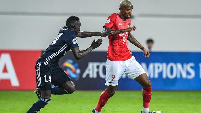 Guangzhou Evergrande’s Talisca, right, was a handful for Melbourne Victory. Picture: AFP