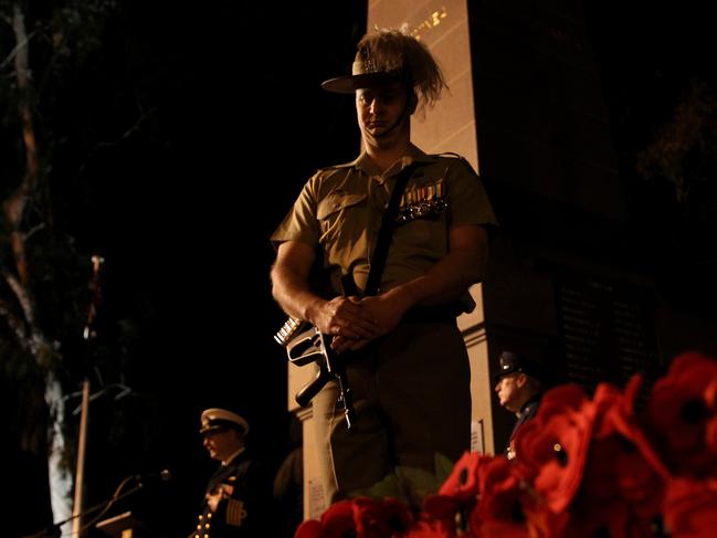 Dawn Service at Parramatta's Prince Alfred Park. A member of the Cataflaque party stands perfectly still alongside the cenotaph.