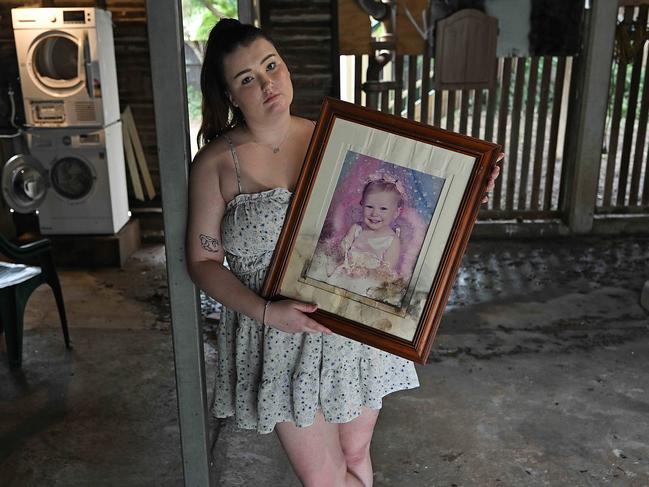 2/122024: Caitlin Thorn, 21, under her home  after being rapidly flooded yesterday, damaging family photographs, and other items,  in Holland Park, Brisbane. pic: Lyndon Mechielsen/Courier Mail