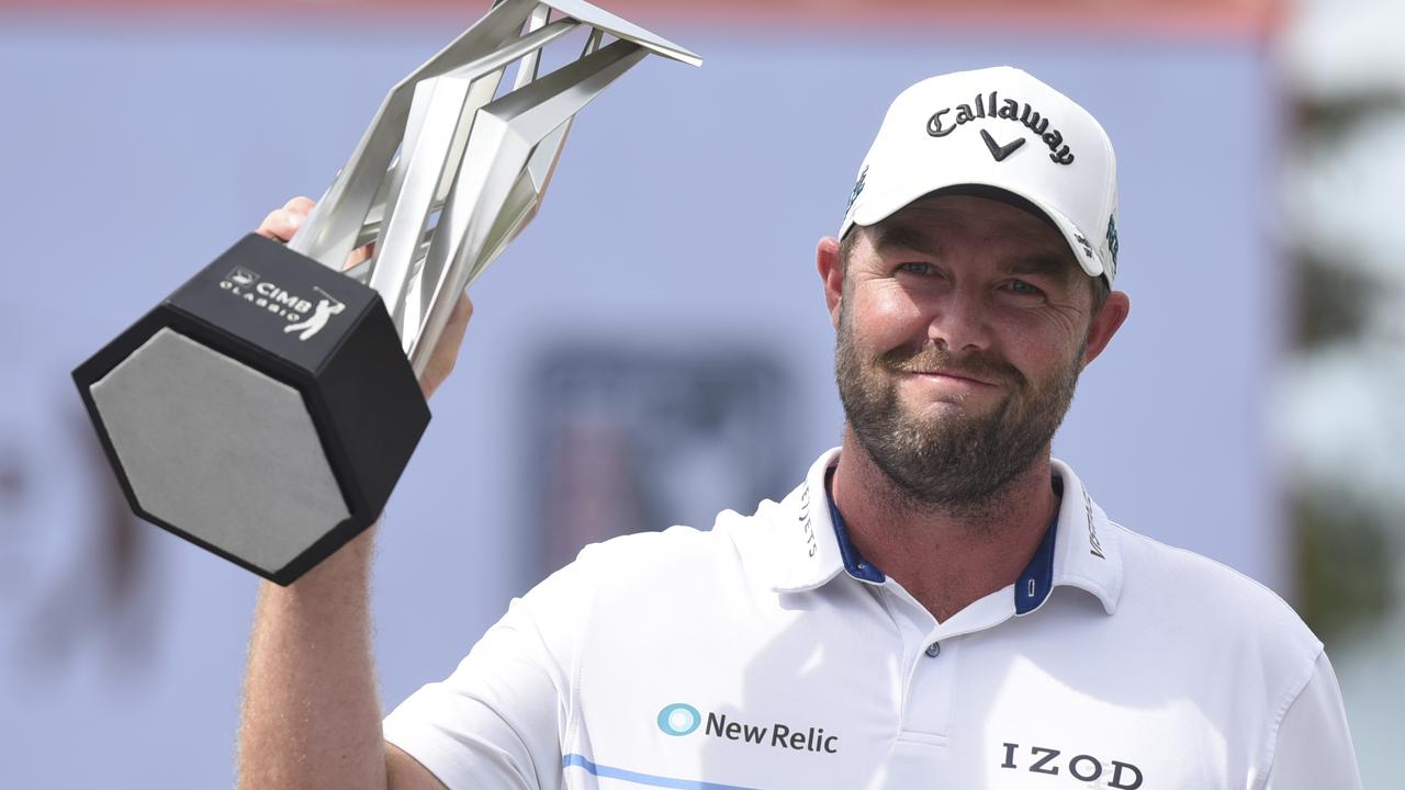 Marc Leishman of Australia raises his trophy after winning the CIMB Classic in Malaysia on Sunday. Picture: AP
