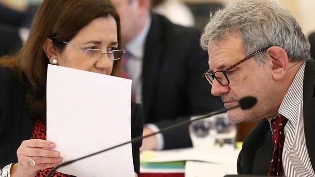 Queensland Premier Annastacia Palaszczuk speaks with Chief of staff David Barbagallo during estimate hearings in July 2019. (AAP Image/Jono Searle)