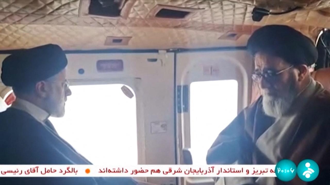 Footage on Iranian state television showed Iran's President Ebrahim Raisi (L) on board a helicopter before reports of an accident. Picture: IRINN / AFP