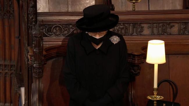 The Queen, alone, inside St George's Chapel today.