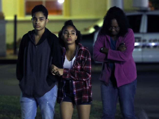 People leave a hotel where students were quickly taken after the mass shooting at the Marjory Stoneman Douglas High School in Florida. Picture: AFP