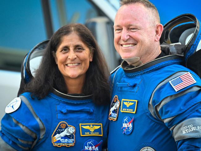 (FILES) NASA astronauts Butch Wilmore (R) and Suni Williams, wearing Boeing spacesuits, depart the Neil A. Armstrong Operations and Checkout Building at Kennedy Space Center for Launch Complex 41 at Cape Canaveral Space Force Station in Florida to board the Boeing CST-100 Starliner spacecraft for the Crew Flight Test launch , on June 5, 2024. Two astronauts stranded in space may sound like the start to a big-screen science thriller, but the Boeing Starliner mission is no work of Hollywood fiction. Astronauts Barry "Butch" Wilmore and Sunita "Suni" Williams were originally scheduled to spend a little more than a week aboard the International Space Station as part of the debut crew flight test of the Starliner. However, the spacecraft encountered several issues during the flight, and now the two astronauts will likely have to extend their stay aboard the ISS for several months. (Photo by Miguel J. Rodriguez Carrillo / AFP)