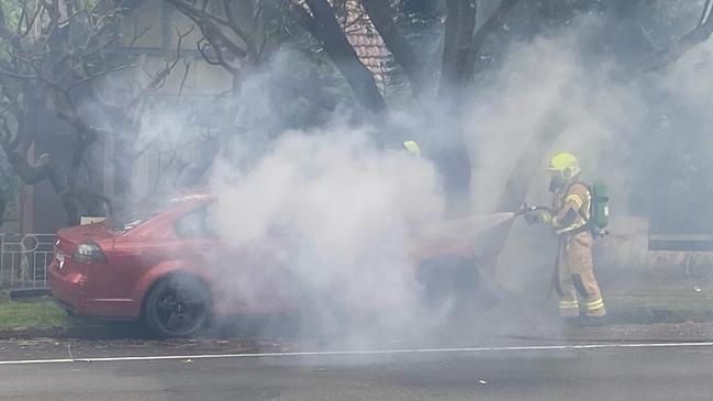 Black smoke was seen billowing from the car after the crash. Picture: Len Walker