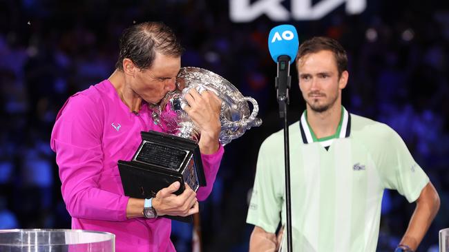 Medvedev looks on as Rafael Nadal kisses the Norman Brookes Challenge Cup. Picture: Getty