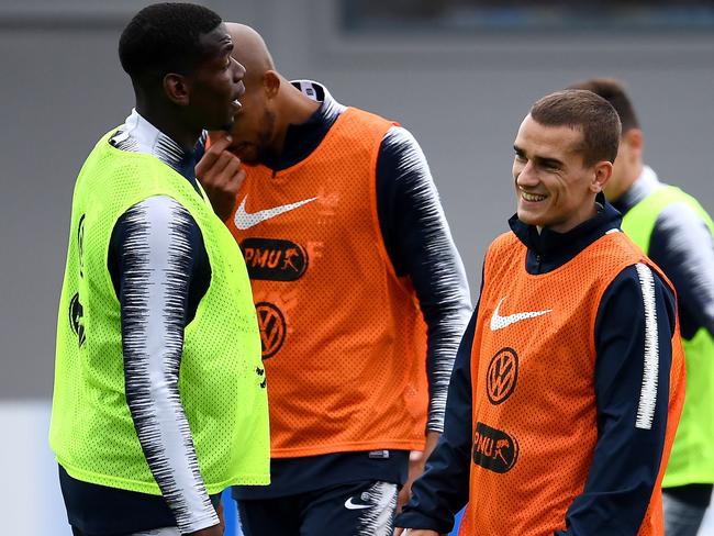 Griezmann (R) shares a laugh with France teammate Paul Pogba. Pic: AFP