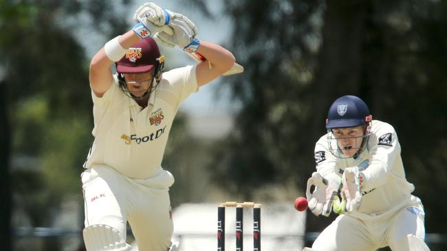 Matthew Renshaw of Queensland lets a ball go through to wicketkeeper Peter Neville in a Sheffield Shield match.